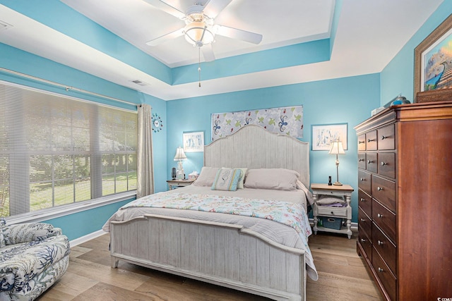 4610 Fringetree Dr, Murrells Inlet, SC 29576 - bedroom with a tray ceiling, wood finished floors, and a ceiling fan