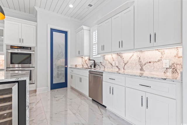 607 Boone Hall Dr, Myrtle Beach, SC 29579 - kitchen featuring appliances with stainless steel finishes, wine cooler, light marble finish flooring, crown molding, and white cabinetry