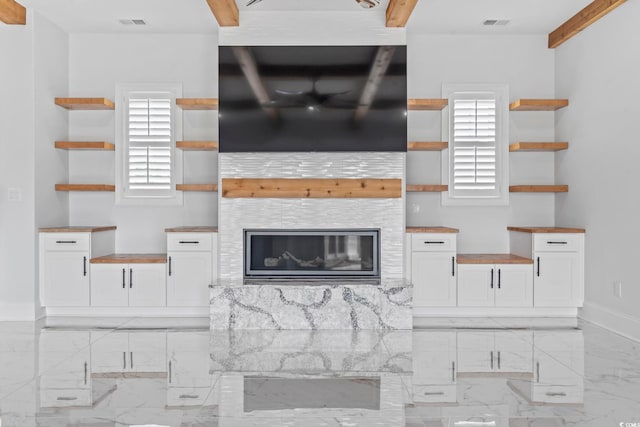 607 Boone Hall Dr, Myrtle Beach, SC 29579 - kitchen with open shelves, butcher block counters, white cabinets, light marble finish flooring, and a tile fireplace