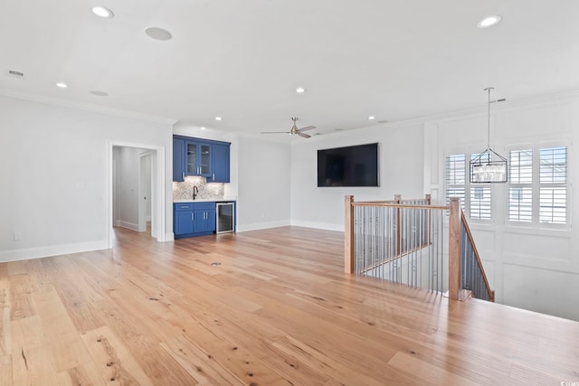 607 Boone Hall Dr, Myrtle Beach, SC 29579 - unfurnished living room with ornamental molding, recessed lighting, light wood finished floors, a chandelier, and a ceiling fan