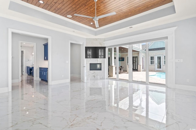 607 Boone Hall Dr, Myrtle Beach, SC 29579 - spare room featuring a tray ceiling, wooden ceiling, light marble finish flooring, ornamental molding, and a ceiling fan