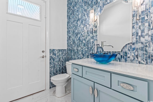 607 Boone Hall Dr, Myrtle Beach, SC 29579 - bathroom featuring vanity, tile walls, marble finish floors, and decorative backsplash