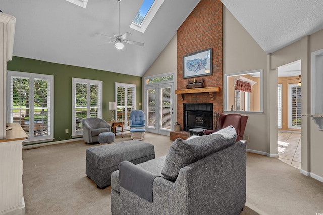 3975 River Hills Dr, Little River, SC 29566 - living room with light carpet, a skylight, a ceiling fan, high vaulted ceiling, and a fireplace