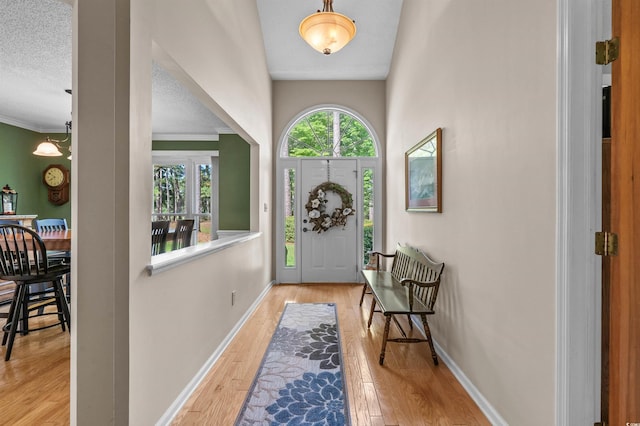 3975 River Hills Dr, Little River, SC 29566 - entrance foyer featuring wood finished floors, crown molding, and a textured ceiling