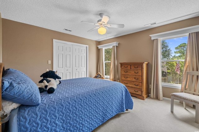3975 River Hills Dr, Little River, SC 29566 - bedroom with multiple windows, light carpet, a closet, ceiling fan, and a textured ceiling