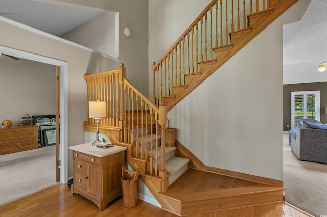 3975 River Hills Dr, Little River, SC 29566 - staircase with wood finished floors, ceiling fan, and carpet