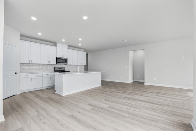 4881 Hopespring St, Myrtle Beach, SC 29579 - kitchen with appliances with stainless steel finishes, recessed lighting, light wood finished floors, white cabinets, and backsplash