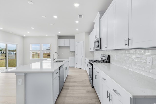 4881 Hopespring St, Myrtle Beach, SC 29579 - kitchen featuring appliances with stainless steel finishes, light wood-style floors, decorative backsplash, recessed lighting, and light countertops