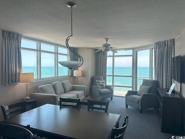 3601 N Ocean Blvd Unit 1139, North Myrtle Beach, SC 29582 - dining room featuring plenty of natural light, a water view, carpet floors, a ceiling fan, and a textured ceiling