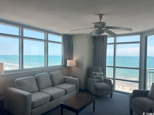 3601 N Ocean Blvd Unit 1139, North Myrtle Beach, SC 29582 - living room with a water view, a textured ceiling, carpet floors, and ceiling fan