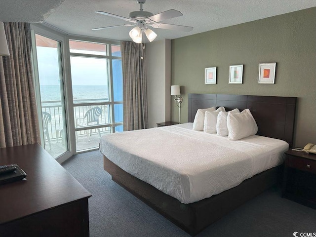 3601 N Ocean Blvd Unit 1139, North Myrtle Beach, SC 29582 - carpeted bedroom featuring access to outside, a textured ceiling, a wall of windows, and ceiling fan