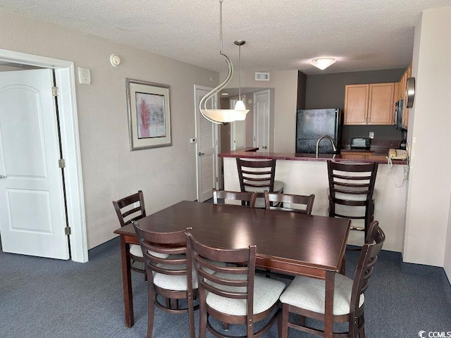3601 N Ocean Blvd Unit 1139, North Myrtle Beach, SC 29582 - dining room with a textured ceiling and dark colored carpet