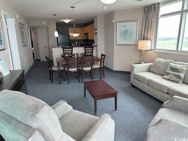3601 N Ocean Blvd Unit 1139, North Myrtle Beach, SC 29582 - carpeted living area featuring a textured ceiling and ceiling fan