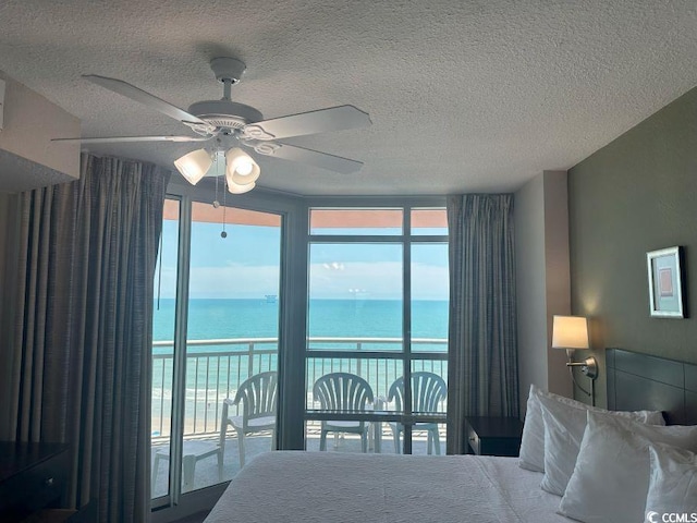 3601 N Ocean Blvd Unit 1139, North Myrtle Beach, SC 29582 - bedroom with a textured ceiling, a water view, access to exterior, multiple windows, and a ceiling fan