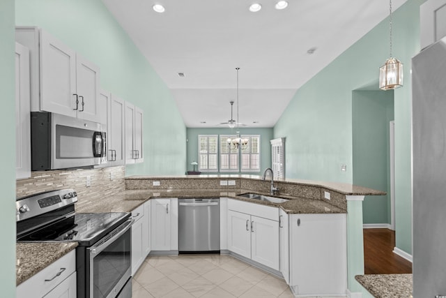 156 Parmelee Dr Unit D, Murrells Inlet, SC 29576 - kitchen with appliances with stainless steel finishes, a peninsula, stone countertops, lofted ceiling, and hanging light fixtures