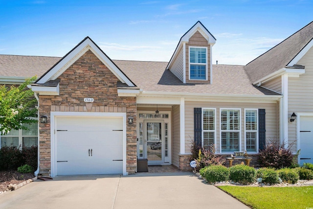 156 Parmelee Dr Unit D, Murrells Inlet, SC 29576 - view of front of property with stone siding, driveway, roof with shingles, and a garage