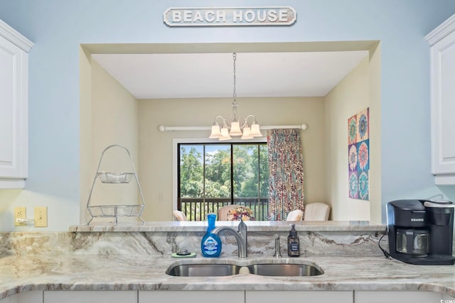 824 Castleford Cir Unit 7C, Myrtle Beach, SC 29572 - kitchen with a chandelier, white cabinets, light stone counters, and pendant lighting