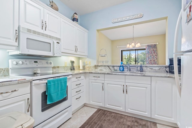 824 Castleford Cir Unit 7C, Myrtle Beach, SC 29572 - kitchen featuring white appliances, a chandelier, white cabinets, hanging light fixtures, and light tile patterned floors