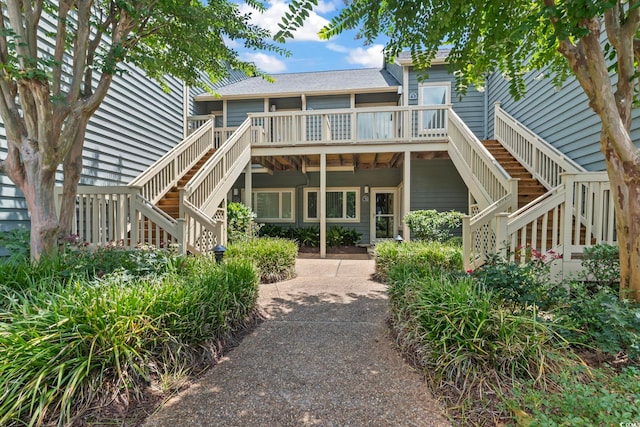 824 Castleford Cir Unit 7C, Myrtle Beach, SC 29572 - rear view of property with stairway, a deck, and a shingled roof