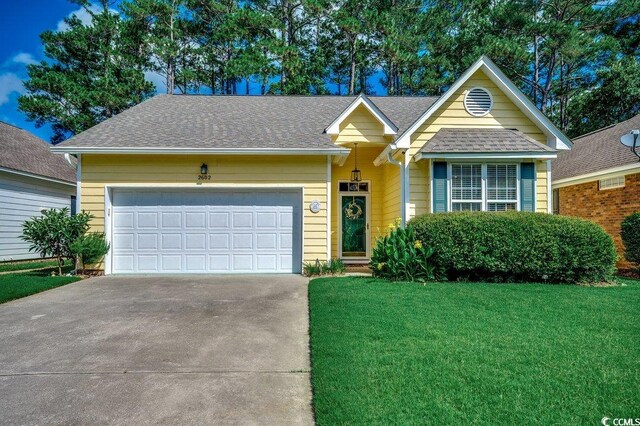 2602 Clearwater St, Myrtle Beach, SC 29579 - view of front of property featuring concrete driveway, a front yard, an attached garage, and roof with shingles
