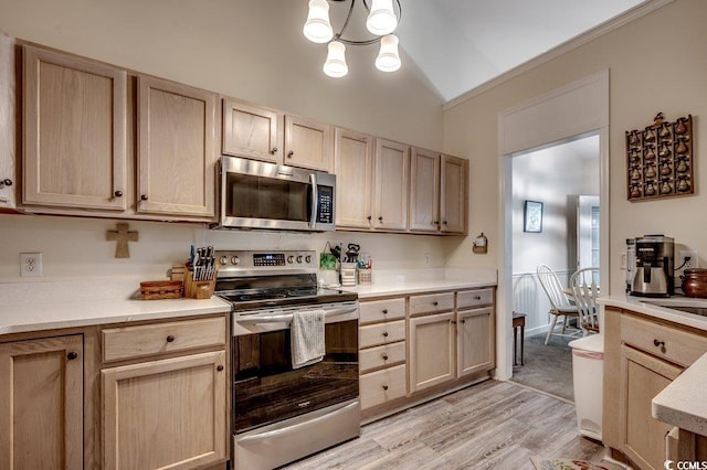 2602 Clearwater St, Myrtle Beach, SC 29579 - kitchen featuring stainless steel appliances, light brown cabinetry, light countertops, vaulted ceiling, and light wood finished floors