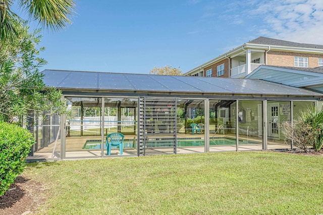 3927 Gladiola Ct Unit 101, Myrtle Beach, SC 29588 - rear view of property featuring an outdoor pool, a patio, and a lawn