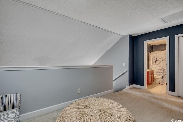 100 Culpepper Way Unit 1002, Myrtle Beach, SC 29579 - unfurnished bedroom featuring carpet, vaulted ceiling, attic access, a textured ceiling, and ensuite bath
