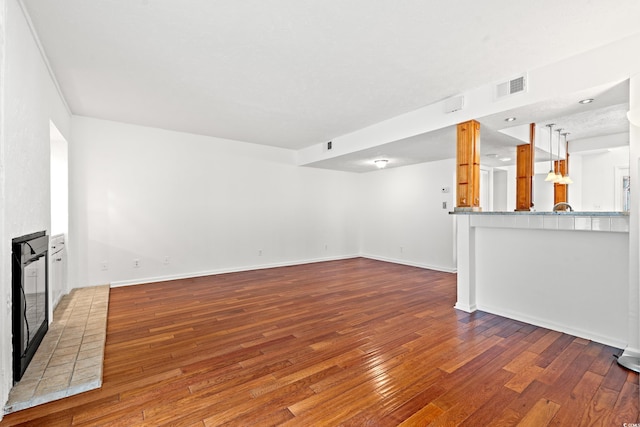 310 74th Ave N Unit 7, Myrtle Beach, SC 29572 - unfurnished living room with hardwood / wood-style floors and a brick fireplace