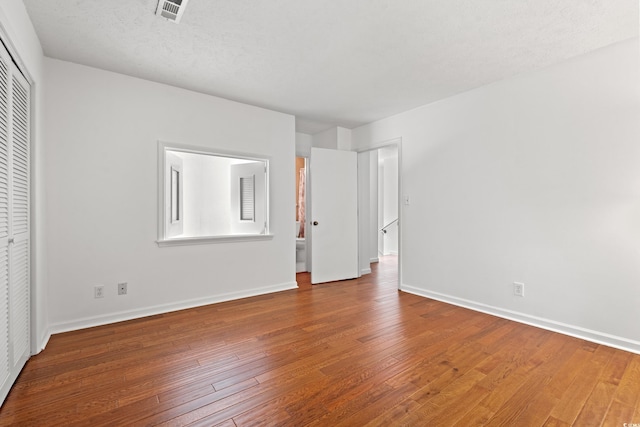 310 74th Ave N Unit 7, Myrtle Beach, SC 29572 - unfurnished bedroom with hardwood / wood-style flooring and a closet