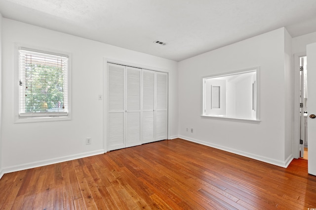 310 74th Ave N Unit 7, Myrtle Beach, SC 29572 - unfurnished bedroom with hardwood / wood-style floors and a closet
