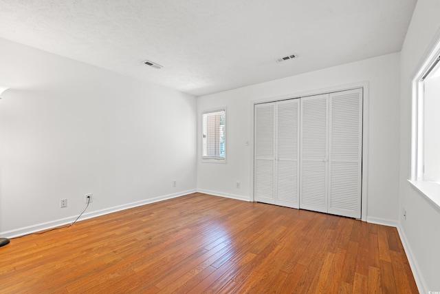 310 74th Ave N Unit 7, Myrtle Beach, SC 29572 - unfurnished bedroom featuring wood finished floors and a closet