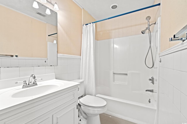 310 74th Ave N Unit 7, Myrtle Beach, SC 29572 - bathroom featuring tile walls, vanity, shower / bath combo with shower curtain, tile patterned flooring, and a wainscoted wall