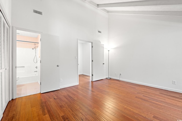 310 74th Ave N Unit 7, Myrtle Beach, SC 29572 - unfurnished bedroom with high vaulted ceiling, hardwood / wood-style flooring, beam ceiling, and ensuite bathroom
