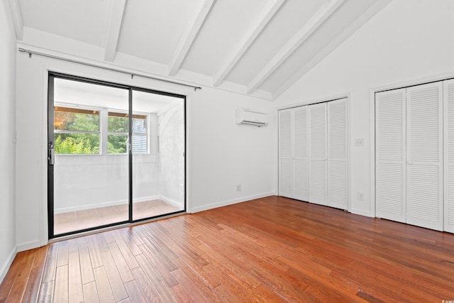 310 74th Ave N Unit 7, Myrtle Beach, SC 29572 - unfurnished bedroom with wood finished floors, two closets, and a wall unit AC