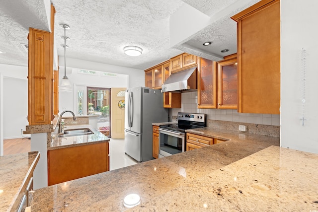 310 74th Ave N Unit 7, Myrtle Beach, SC 29572 - kitchen with brown cabinets, light stone counters, a textured ceiling, stainless steel appliances, and decorative backsplash