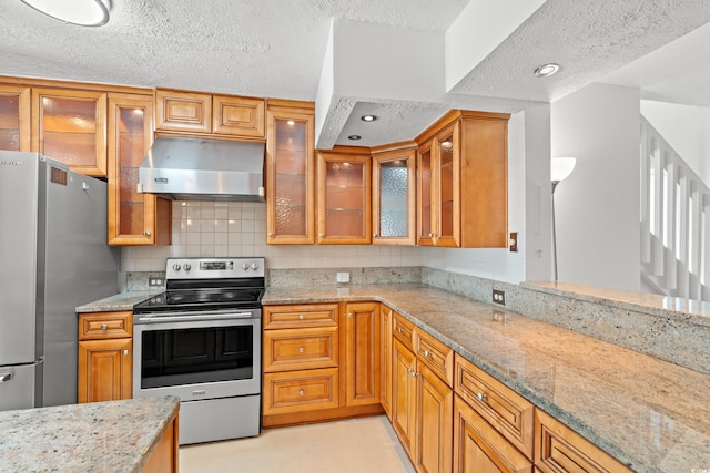 310 74th Ave N Unit 7, Myrtle Beach, SC 29572 - kitchen with stainless steel appliances, extractor fan, a textured ceiling, light stone counters, and decorative backsplash