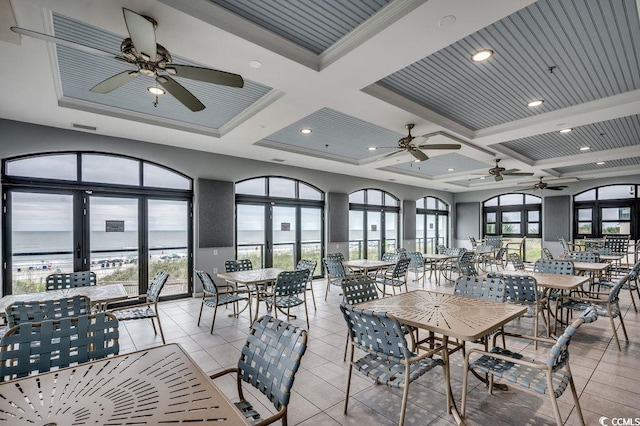 2450 Marsh Glen Dr Unit 112, North Myrtle Beach, SC 29582 - dining area featuring a ceiling fan, coffered ceiling, light tile patterned floors, and beam ceiling