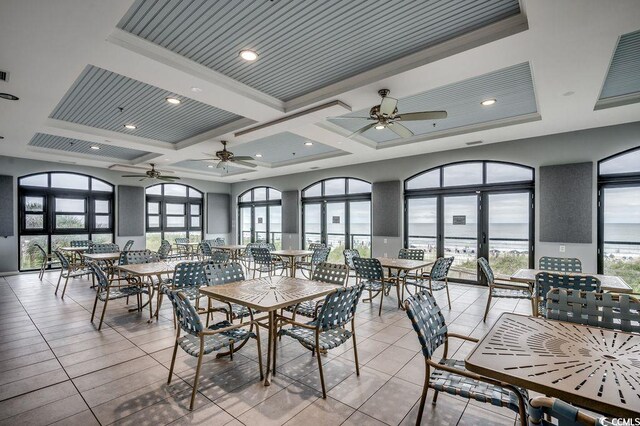 2450 Marsh Glen Dr Unit 112, North Myrtle Beach, SC 29582 - dining area featuring ceiling fan, healthy amount of natural light, light tile patterned flooring, coffered ceiling, and crown molding