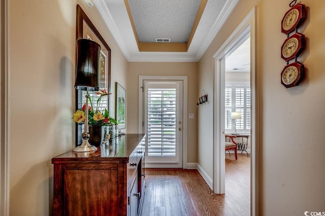 2450 Marsh Glen Dr Unit 112, North Myrtle Beach, SC 29582 - doorway to outside featuring wood finished floors, a tray ceiling, and ornamental molding