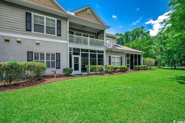 2450 Marsh Glen Dr Unit 112, North Myrtle Beach, SC 29582 - rear view of house featuring a balcony, a yard, ceiling fan, and a sunroom