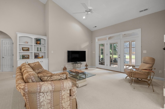 907 Tidewater Dr, North Myrtle Beach, SC 29582 - living room with high vaulted ceiling, light carpet, arched walkways, ceiling fan, and french doors