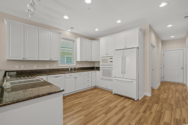 907 Tidewater Dr, North Myrtle Beach, SC 29582 - kitchen featuring white appliances, light wood-style flooring, white cabinets, and recessed lighting
