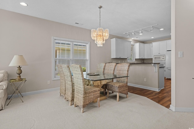 907 Tidewater Dr, North Myrtle Beach, SC 29582 - dining space featuring a chandelier, carpet floors, wood finished floors, track lighting, and recessed lighting