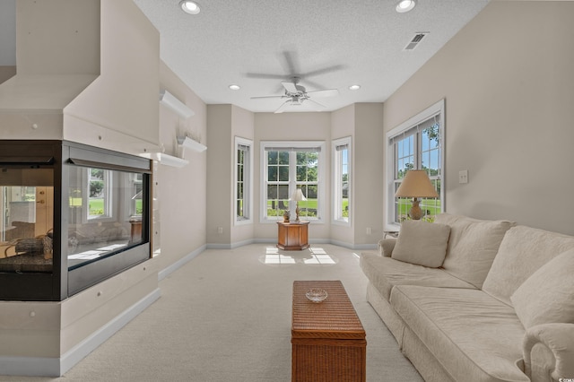 907 Tidewater Dr, North Myrtle Beach, SC 29582 - carpeted living room featuring recessed lighting, a textured ceiling, and a ceiling fan