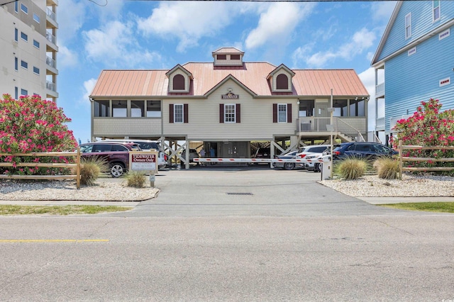907 Tidewater Dr, North Myrtle Beach, SC 29582 - view of building exterior with uncovered parking and stairway