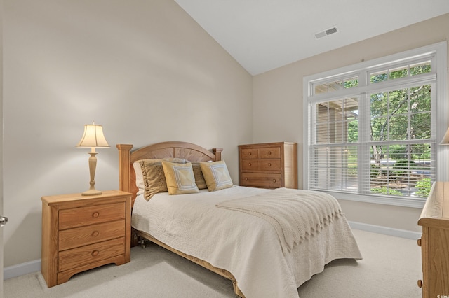 907 Tidewater Dr, North Myrtle Beach, SC 29582 - bedroom with light colored carpet, vaulted ceiling, and multiple windows