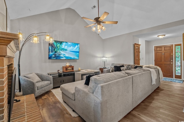 311 Ashwood Ln, Myrtle Beach, SC 29588 - living room featuring wood finished floors, a brick fireplace, a ceiling fan, and high vaulted ceiling