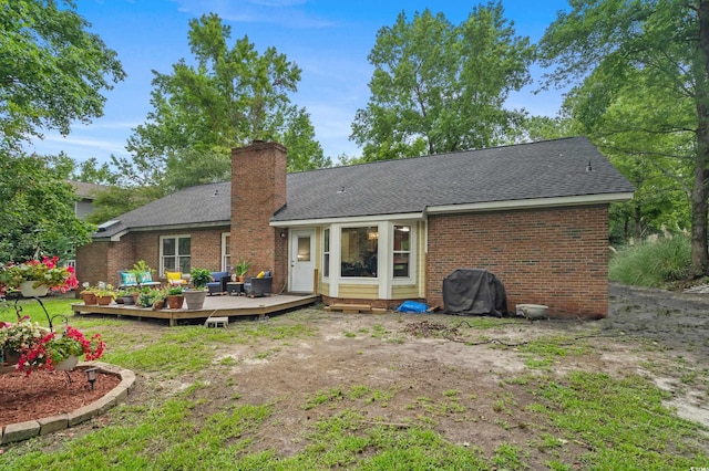 311 Ashwood Ln, Myrtle Beach, SC 29588 - back of house with a deck, brick siding, roof with shingles, and a chimney