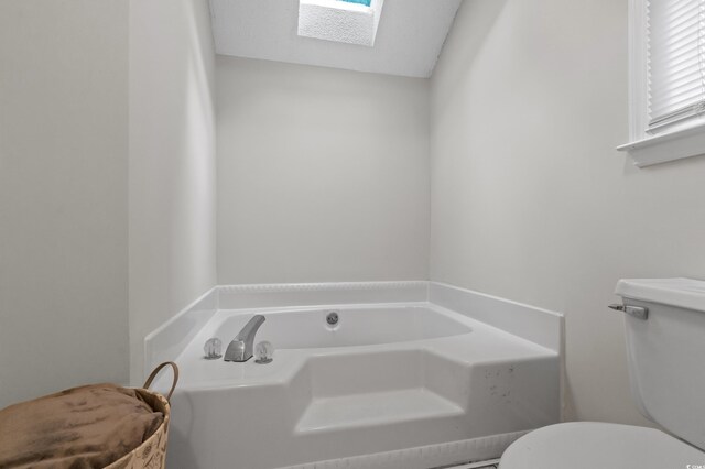 311 Ashwood Ln, Myrtle Beach, SC 29588 - bathroom featuring a skylight and a garden tub