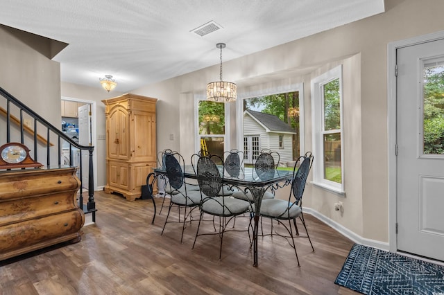 311 Ashwood Ln, Myrtle Beach, SC 29588 - dining space with a chandelier, wood finished floors, and stairs